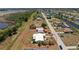 Aerial view showcases property with white roof and fenced backyard surrounded by a peaceful neighborhood and canals at 113 Annapolis Ln, Rotonda West, FL 33947