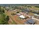 Aerial view of a fenced property with a white roof, nestled in a community with canals and lush greenery at 113 Annapolis Ln, Rotonda West, FL 33947