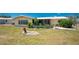 View of backyard landscaping and a paver patio featuring a grill and room for outdoor activities at 113 Annapolis Ln, Rotonda West, FL 33947