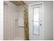 Neutral tiled shower featuring a palm-themed shower curtain and a convenient towel rack, enhancing the bathroom's functionality at 113 Annapolis Ln, Rotonda West, FL 33947