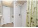 Shower with tiled walls and a shower curtain with palm tree pattern at 113 Annapolis Ln, Rotonda West, FL 33947