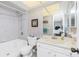 Bright bathroom featuring a tub-shower combo, vanity, and neutral wall coverings at 113 Annapolis Ln, Rotonda West, FL 33947