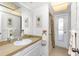 Bright bathroom featuring a vanity, framed art, and a door into the shower at 113 Annapolis Ln, Rotonda West, FL 33947