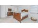Bright bedroom showcasing a wooden bed frame, lots of natural light, and an antique dresser at 113 Annapolis Ln, Rotonda West, FL 33947