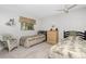 Bedroom with two beds, white walls, ceiling fan, and wicker chair at 113 Annapolis Ln, Rotonda West, FL 33947