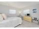 Bedroom with white walls, two windows, bed, dresser, and ceiling fan at 113 Annapolis Ln, Rotonda West, FL 33947