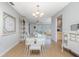 Bright dining room with neutral decor, light wood floors and seamless flow into the living spaces at 113 Annapolis Ln, Rotonda West, FL 33947