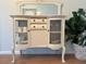 Charming dining room hutch featuring glass doors, drawers, and a decorative mirror at 113 Annapolis Ln, Rotonda West, FL 33947