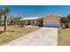 Charming single-story home featuring an attached garage, well-manicured lawn and a concrete driveway at 113 Annapolis Ln, Rotonda West, FL 33947