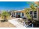 Inviting front yard with walkway, tropical plants, and a charming home with blue shutters at 113 Annapolis Ln, Rotonda West, FL 33947