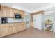 Bright kitchen featuring tile floors, stainless steel appliances, wood cabinets, and granite countertops at 113 Annapolis Ln, Rotonda West, FL 33947