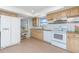Bright kitchen featuring tile flooring, white appliances, wood cabinets and granite counters, offering ample space at 113 Annapolis Ln, Rotonda West, FL 33947