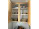 Open kitchen cabinets showcase ample storage space for dishes and kitchenware at 113 Annapolis Ln, Rotonda West, FL 33947