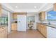 Charming kitchen featuring tile floors, stainless steel appliances, wood cabinets, and granite countertops at 113 Annapolis Ln, Rotonda West, FL 33947