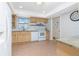 Traditional kitchen with tile flooring, bright white appliances, and wooden cabinets with granite countertops at 113 Annapolis Ln, Rotonda West, FL 33947