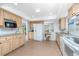 Open kitchen showcasing tile floors, stainless steel appliances, wood cabinets, and granite countertops at 113 Annapolis Ln, Rotonda West, FL 33947