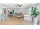 Bright living room with neutral walls, wood floors, and large plants near the windows at 113 Annapolis Ln, Rotonda West, FL 33947