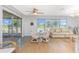Inviting living area showcasing a glass table, comfortable couch, and sliding doors to an outdoor patio at 113 Annapolis Ln, Rotonda West, FL 33947