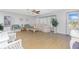 Inviting living room with comfortable seating, ceiling fan, and natural light from large windows at 113 Annapolis Ln, Rotonda West, FL 33947