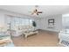 Bright living room featuring neutral walls, wood floors, and large windows for natural light at 113 Annapolis Ln, Rotonda West, FL 33947