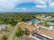 An elevated view shows the property within a serene residential area near a beautiful lake at 1155 Osceola Blvd, Englewood, FL 34223
