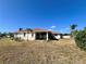 This backyard features a well-maintained lawn and access to a screened in porch at 1155 Osceola Blvd, Englewood, FL 34223