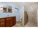 This bathroom features a gorgeous wooden vanity with granite countertop and a walk-in shower at 1155 Osceola Blvd, Englewood, FL 34223