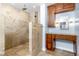 This bathroom features a walk-in shower with a shower head and a gorgeous wooden vanity at 1155 Osceola Blvd, Englewood, FL 34223