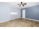 This bedroom features tile floors, ceiling fan, and natural light from the windows at 1155 Osceola Blvd, Englewood, FL 34223