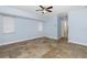 This bedroom features tile floors, ceiling fan, and natural light from the windows at 1155 Osceola Blvd, Englewood, FL 34223