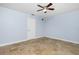 This bedroom features tile floors, ceiling fan, and natural light from the windows at 1155 Osceola Blvd, Englewood, FL 34223