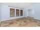 Inviting bedroom featuring three windows, tiled flooring and a connecting arched doorway at 1155 Osceola Blvd, Englewood, FL 34223