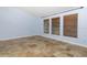 Spacious bedroom with natural light from three windows and tile flooring at 1155 Osceola Blvd, Englewood, FL 34223