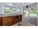 Kitchen featuring granite countertops, modern appliances, access to the outdoor patio, and tiled floors at 1155 Osceola Blvd, Englewood, FL 34223