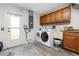 This laundry room features a washer, dryer, sink, and cabinetry at 1155 Osceola Blvd, Englewood, FL 34223