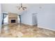 Spacious living room with tile flooring and a charming brick fireplace feature at 1155 Osceola Blvd, Englewood, FL 34223