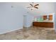 Open-concept living area with travertine tile floors and seamless flow into the modern kitchen at 1155 Osceola Blvd, Englewood, FL 34223