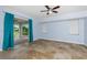 Bright living room featuring travertine floors and access to the screened patio with lots of space at 1155 Osceola Blvd, Englewood, FL 34223