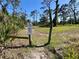 Scenic walking path entrance with signage indicating pet-friendly rules and restrictions at 1155 Osceola Blvd, Englewood, FL 34223