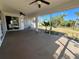 Relaxing screened patio with ceiling fans offering views of the landscaped backyard at 1155 Osceola Blvd, Englewood, FL 34223