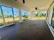 Relaxing screened patio with ceiling fan offering views of the landscaped backyard at 1155 Osceola Blvd, Englewood, FL 34223