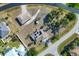Aerial view of home, showcasing landscaping, a circular driveway, and backyard at 11869 Newgate Ave, Port Charlotte, FL 33981