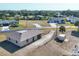 Aerial view of a small home on a large lot on a quiet street at 11869 Newgate Ave, Port Charlotte, FL 33981