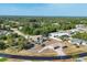 Neighborhood with mature landscaping and houses that feature driveways and attached garages at 11869 Newgate Ave, Port Charlotte, FL 33981