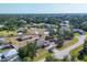 Neighborhood with mature landscaping and houses that feature driveways and attached garages at 11869 Newgate Ave, Port Charlotte, FL 33981