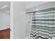 Bathroom shower featuring white tiles and a striped shower curtain at 11869 Newgate Ave, Port Charlotte, FL 33981