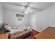 Simple bedroom with a window, ceiling fan and comfortable-looking quilt at 11869 Newgate Ave, Port Charlotte, FL 33981