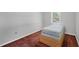 Simple bedroom featuring a bed frame and small window at 11869 Newgate Ave, Port Charlotte, FL 33981