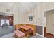 Cozy dining area with wooden bench seating and unique light fixture at 11869 Newgate Ave, Port Charlotte, FL 33981