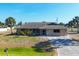 Charming single-story home with a well-maintained lawn, complemented by palm trees and a long driveway at 11869 Newgate Ave, Port Charlotte, FL 33981